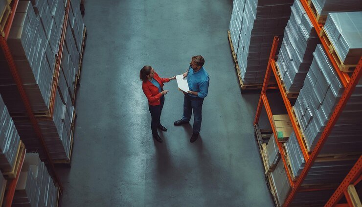 Two people are talking with each other in warehouse